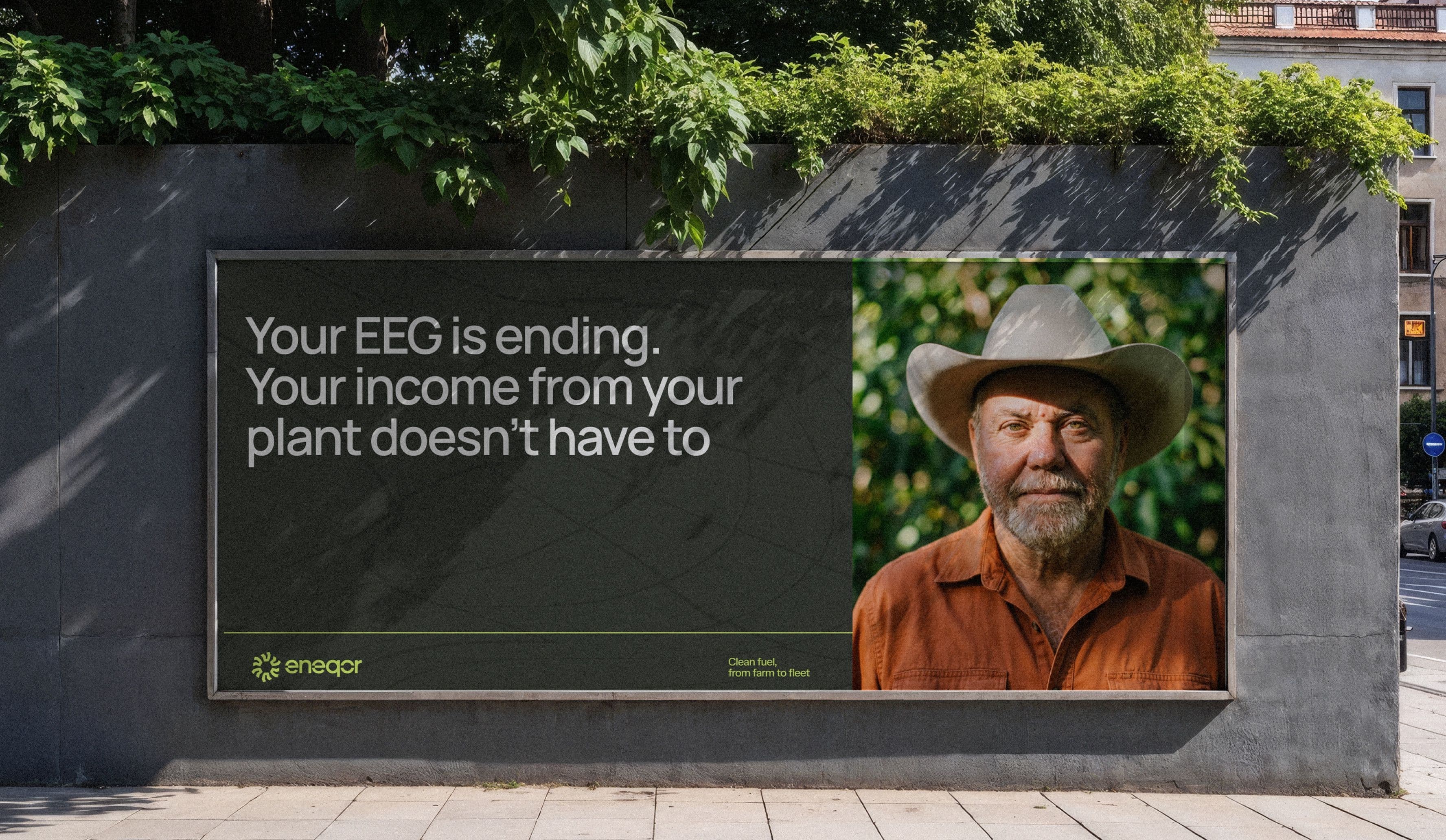 Білборд Eneqor на міській стіні з портретом фермера: Your EEG is ending. Your income from your plant doesn't have to